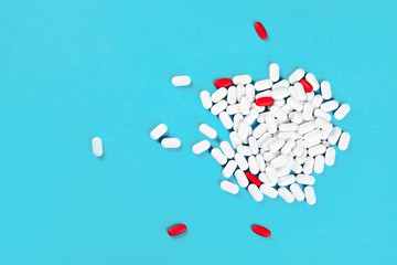 Heap of pills on blue background
