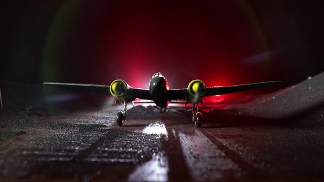 German night bomber at night. Artwork decoration with scale model of jet-propelled plane in possession. Toned foggy background with light. War scene. Selective focus