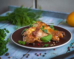 Hearty lunch with baked chicken drumsticks with aromatic herbs and colorful peas