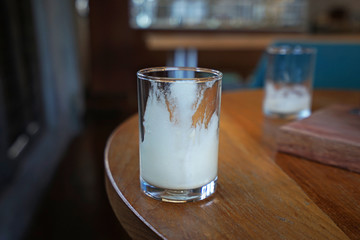 Close up glass of empty after drink coffee on wooden table