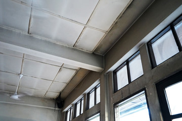 Interior loft design and ceiling decoration cement concrete building decorated with wooden mirror frame and hanging electric fan