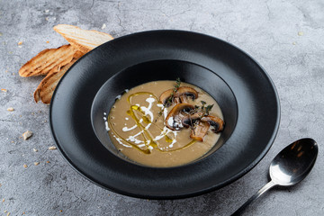 Porcini mushrooms cream soup with rich cream and crunchy toasts