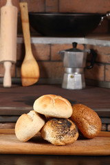 Assortment of bread rolls at rural kitchen background