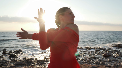 Woman on sea shore stretching before workout