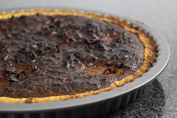 Freshly baked tart in baking tin. Making Chocolate, Pear and Pecan Pie Series.