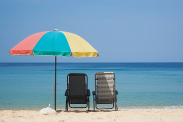 Two beach chairs and an umbrella on the beach