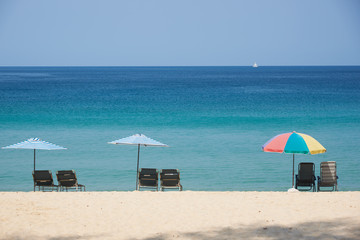 Row of beach chairs and umbrellas on the beach