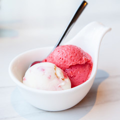 Raspberry and yogurt ice cream served on mini white bowl