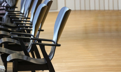 Empoty cafe black wood chairs row with copy space background.