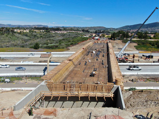 Aerial view of bridge construction crossing the highway, California, USA
