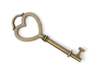 old brass key against a white background