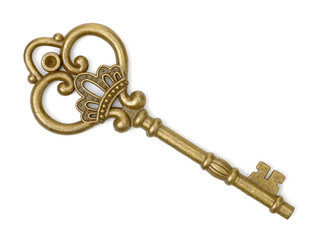 old brass key against a white background