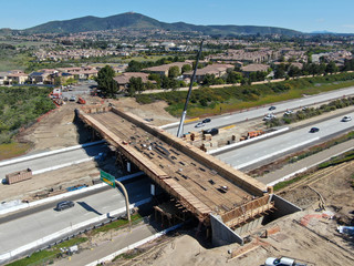 Aerial view of bridge construction crossing the highway, California, USA