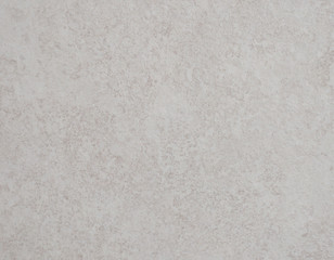 The polished surface of gray marble with a splash of fine fraction close-up.