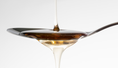 Natural Honey syrup on the spoon
