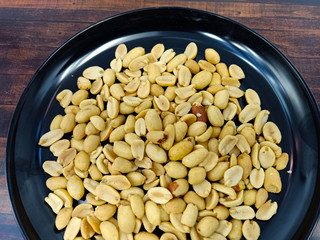 fresh roasted peanuts served on a black plate