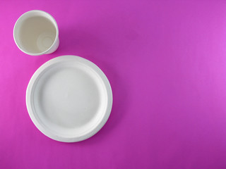 Recycled paper container on a bright pink background.