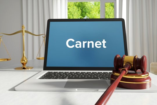Carnet – Law, Judgment, Web. Laptop in the office with term on the screen. Hammer, Libra, Lawyer.