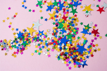 Colorful stars on violet background. Carnival, party decor.