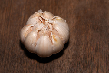 Close-up of garlic photos with a wooden board background.
