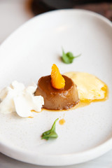 Coffee pudding served with whipped cream and passion fruit mousse