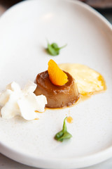 Coffee pudding served with whipped cream and passion fruit mousse