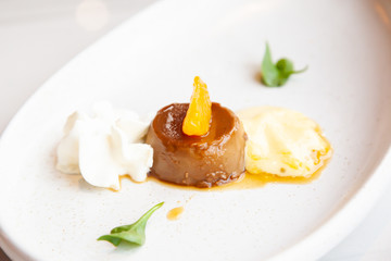 Coffee pudding served with whipped cream and passion fruit mousse