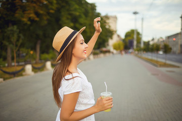 A young girl welcomes friends on a city street.