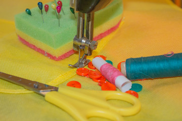 Sewing still life: colorful cloth. Sewing kit includes threads of different colors, thimble and other sewing accessories
