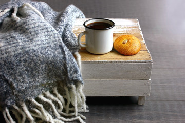 Iron mug with coffee, cookies, mohair plaid, rustic wooden mini table