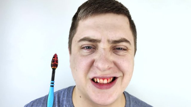 Toothbrush with blood closeup. A man discovered bleeding gums while brushing her teeth. Gingivitis or periodontal disease