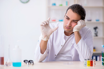 Young male chemist working in the lab