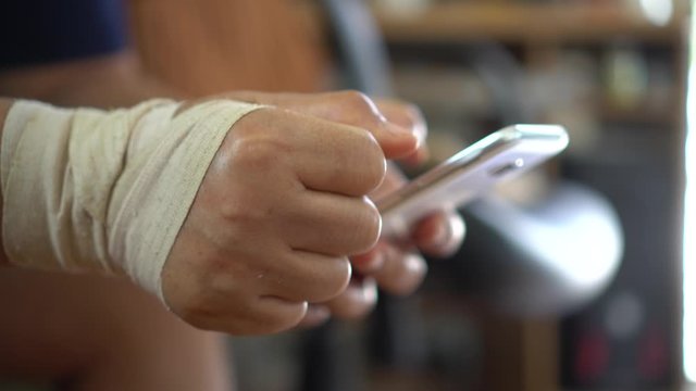 Trigger finger or Finger Lock Disease, Office syndrome technology concept. Businessman trying use smartphone while trigger digits or trigger thumb with pain, Myocardial pain syndrome nerve elbow