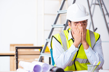 Young male architect working indoors