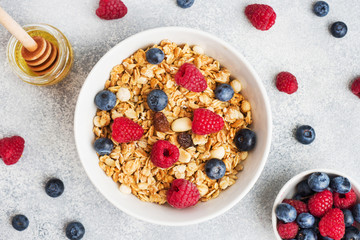 Healthy breakfast. Fresh granola, muesli with yogurt and berries on grey background. Copy space - obrazy, fototapety, plakaty
