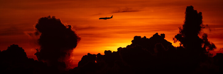 Silhouette of passenger airplane with the morning sunrise background