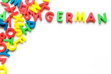Learn German. Concept with letters on white background top-down copy space