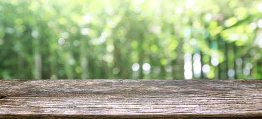  Wood table display over blur green tree garden