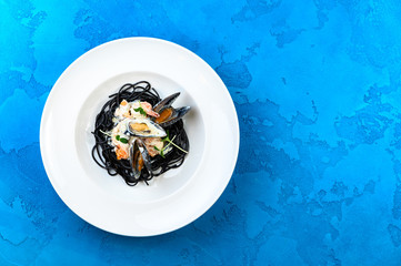 Tasty pasta in big white plate blue background