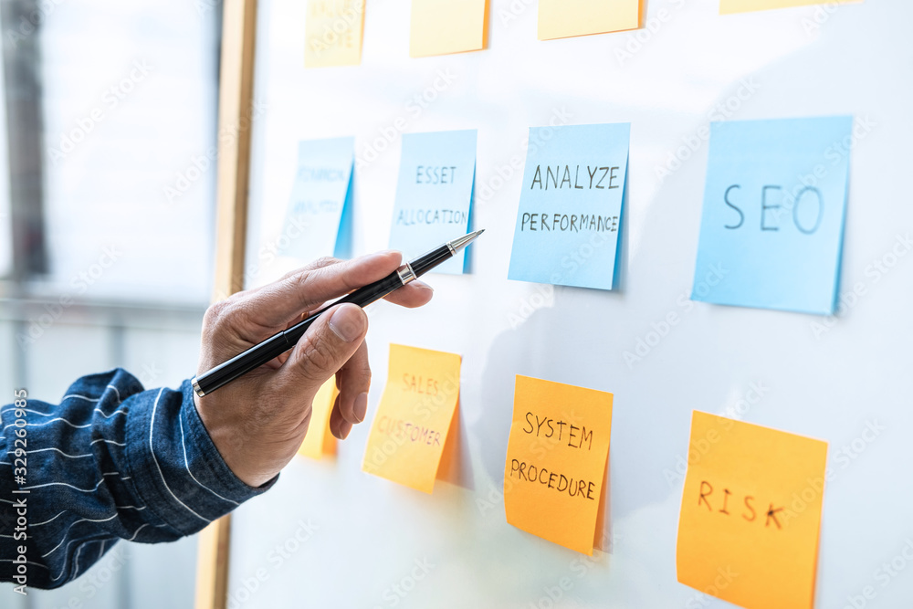 Poster young creative business people use post it notes sticky note on board to share idea, analysis data c