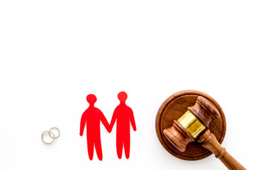 LGBT divorce. Judge gavel, rings, men gay couple on white background top-down copy space