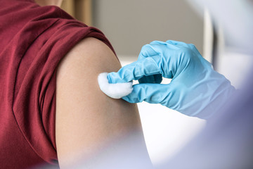 Doctor making injection vaccination patient to prevent pandemic of the disease, flu or influenza...