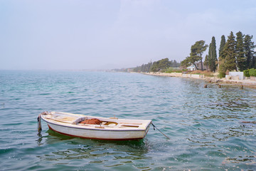 Naklejka premium Beautiful landscape with seashore and fishing boat.
