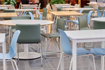 Modern tables and blue chairs in shopping malls.