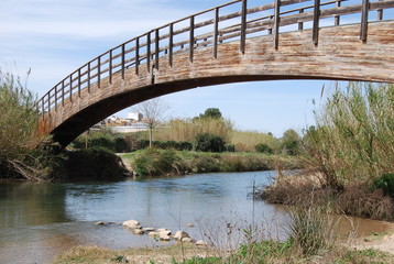 Curved Wooden Bridge over River Turia, Spain