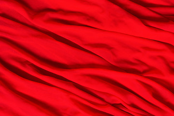 Red waves of fabric textile. Beautiful fashion design background for holiday