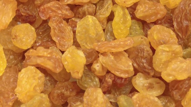 Golden raisins rotate. Close up. The view from the top