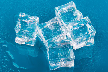 ice cubes and water drops close up on blue background
