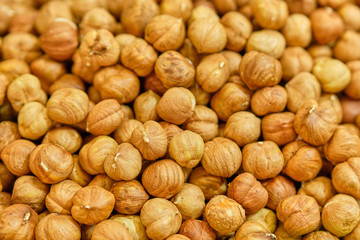 Background texture of peeled hazelnuts. Top view.