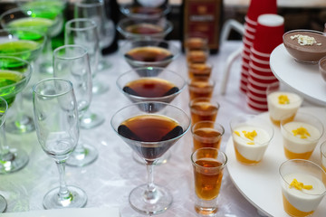 Festive table with cold exotic alcoholic beverages, cocktails. Party and holiday celebration concept